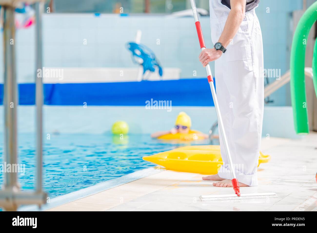 Piscina pulita. Lavoratore caucasica la cura della piscina. Foto Stock