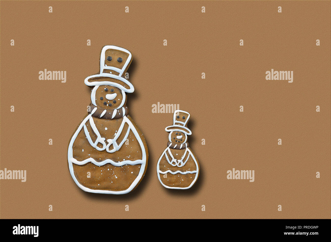 Due gingerbread pupazzi di neve, isolato su sfondo marrone, close up, llay piana, spazio di copia Foto Stock