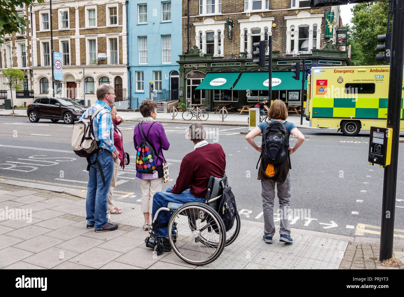 Londra Inghilterra,Regno Unito,Lambeth North,Kennington Road,attraversamento di strada,uomo uomo maschio,donna donna donna donne,disabili disabili esigenze speciali,sedia a rotelle,famiglia f Foto Stock