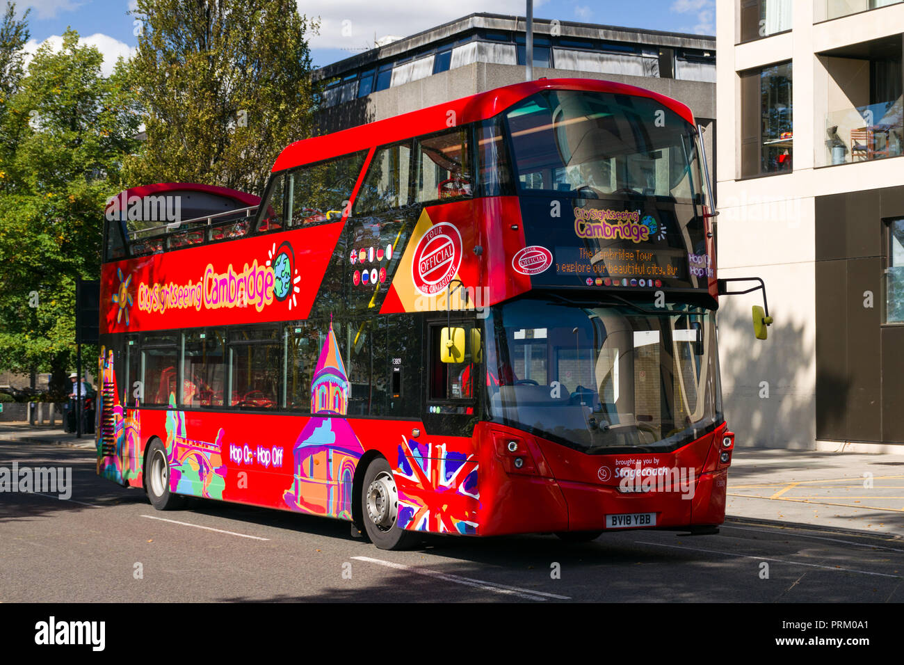 Un rosso open top double decker City sightseeing bus la guida su strada, Cambridge, Regno Unito Foto Stock