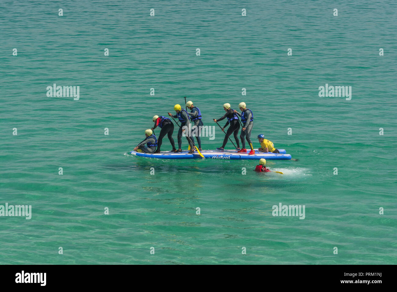 Giant Stand-Up / SUP Paddle Board con gruppo di rematori. Foto Stock