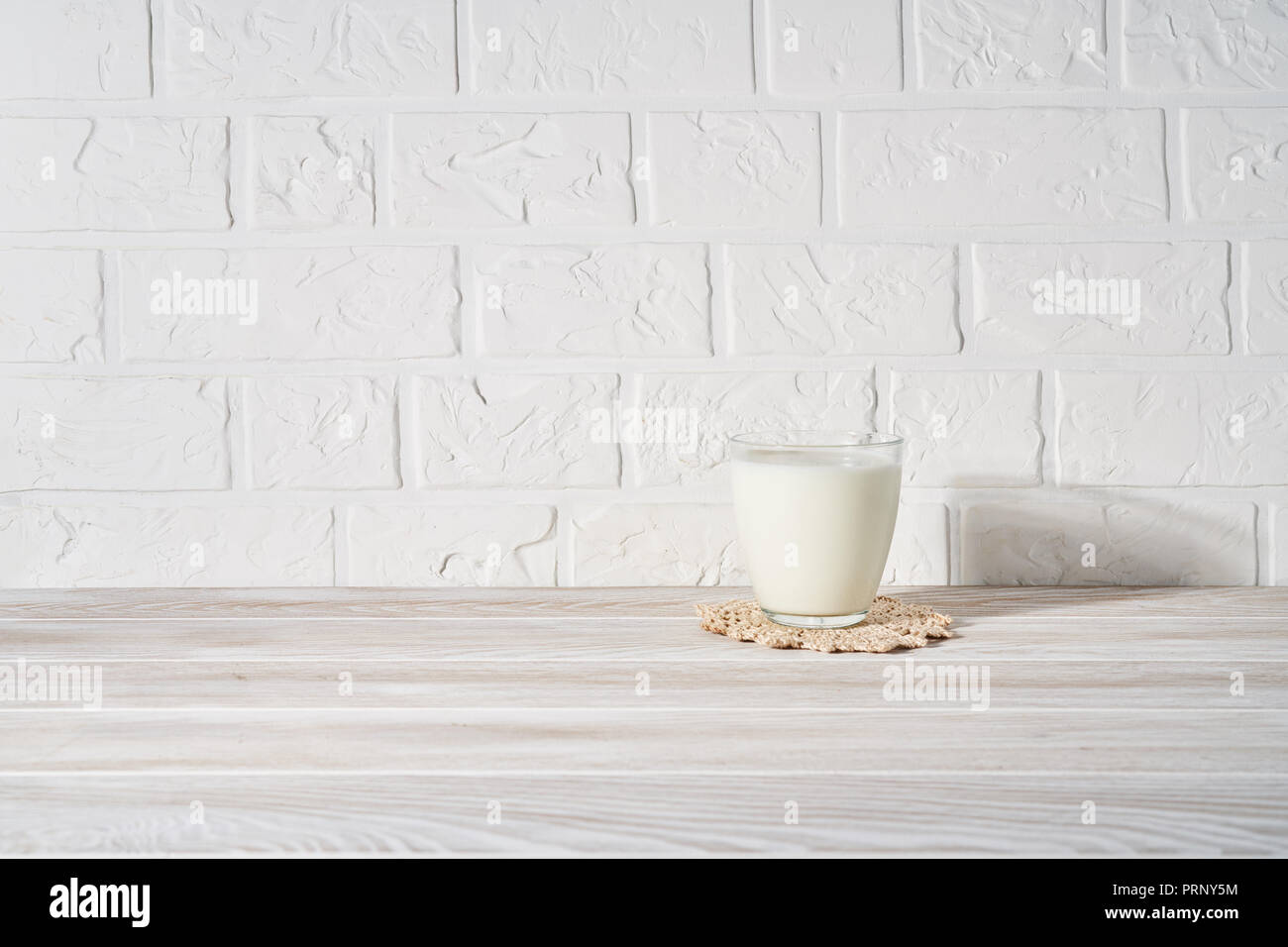 Bicchiere di latte bianco su sfondo di legno. Foto Stock