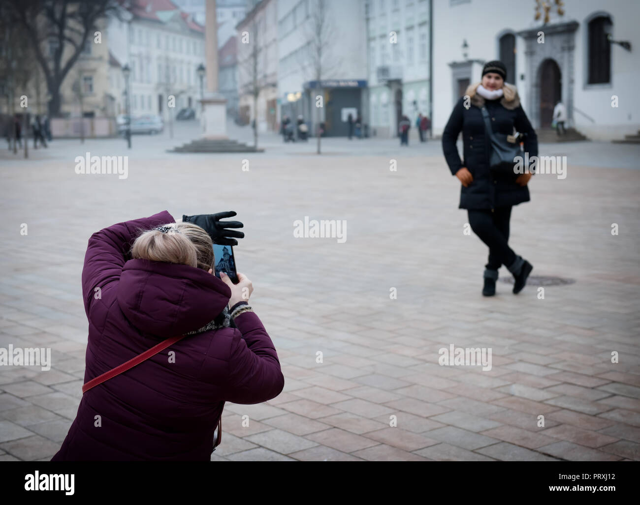 Un amico prende un'altra foto. Amiche sono fotografato vicino a attrazioni Foto Stock