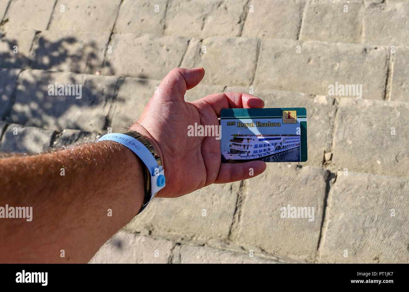 Una mano d'uomo in possesso di una carta d'imbarco per un fiume Nilo nave da crociera chiamata M/S Royal Esadora, Egitto, Africa Foto Stock