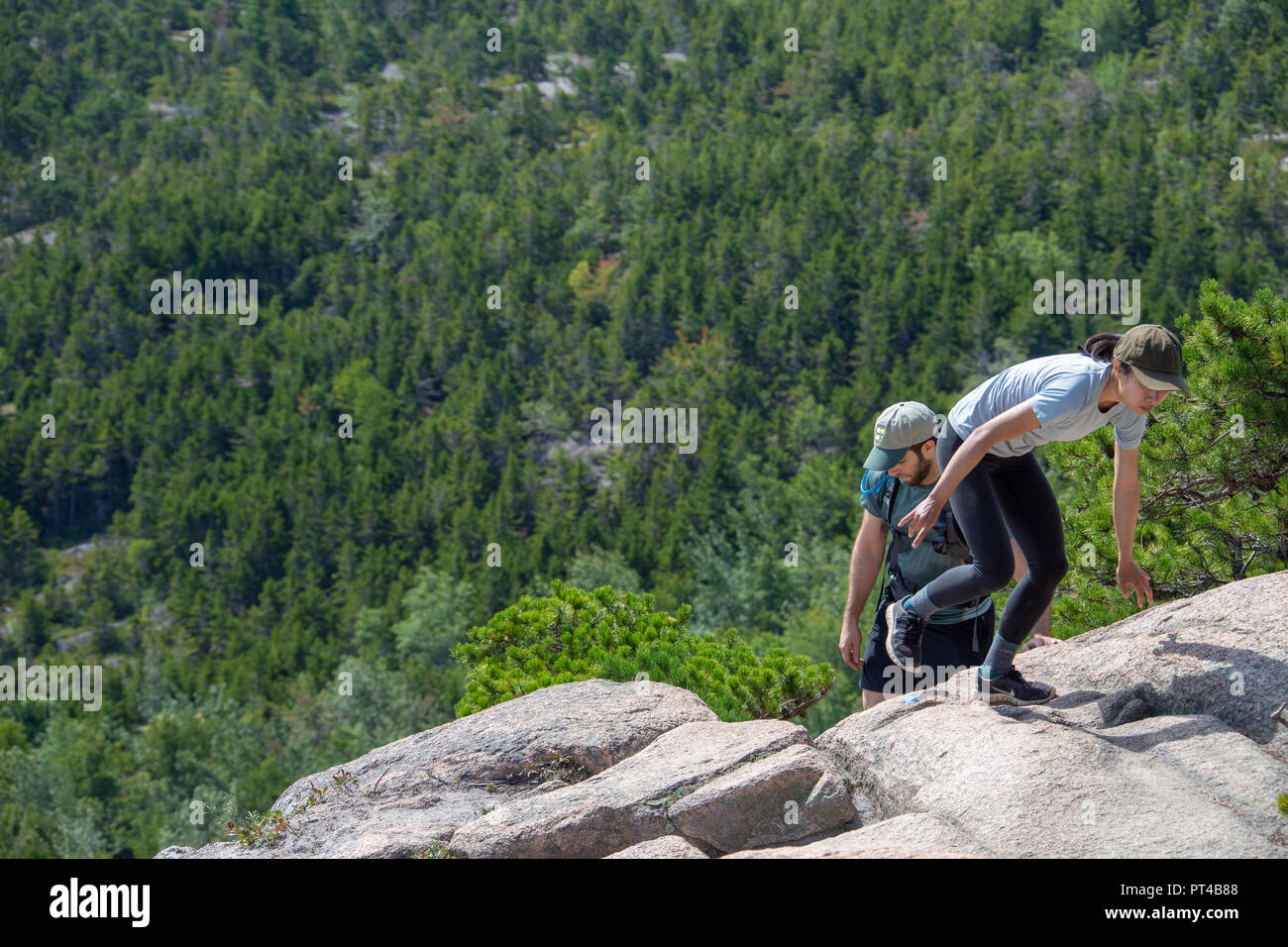 I giovani escursionisti fino scrambling Beehive Trail, Bar Harbor, ME 04609, STATI UNITI D'AMERICA Foto Stock