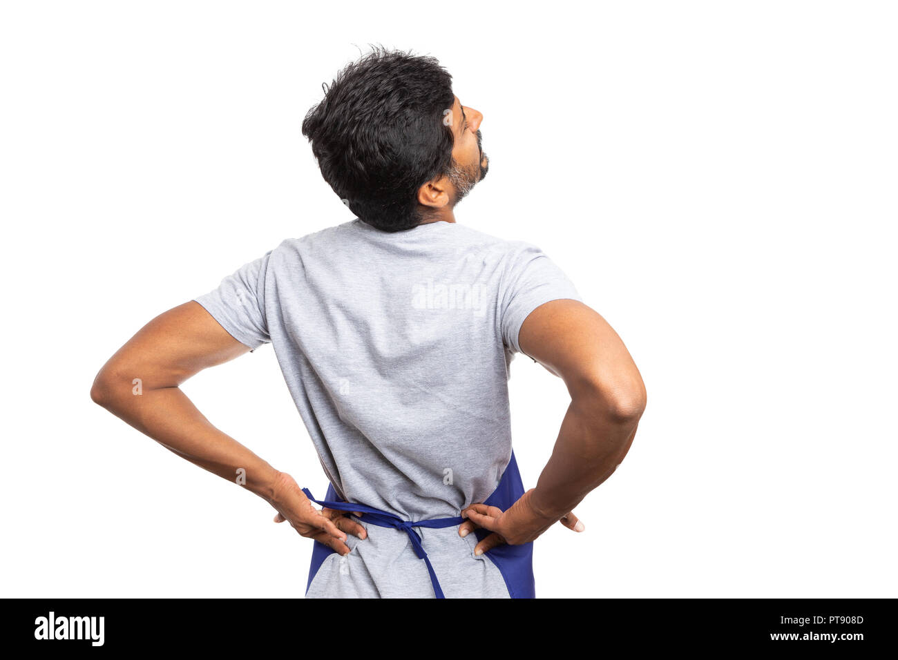 Ipermercato indiano o supermercato uomo dipendente toccando indolenzito inferiore della schiena con entrambe le mani come disagio concetto isolato su bianco di sfondo per studio Foto Stock
