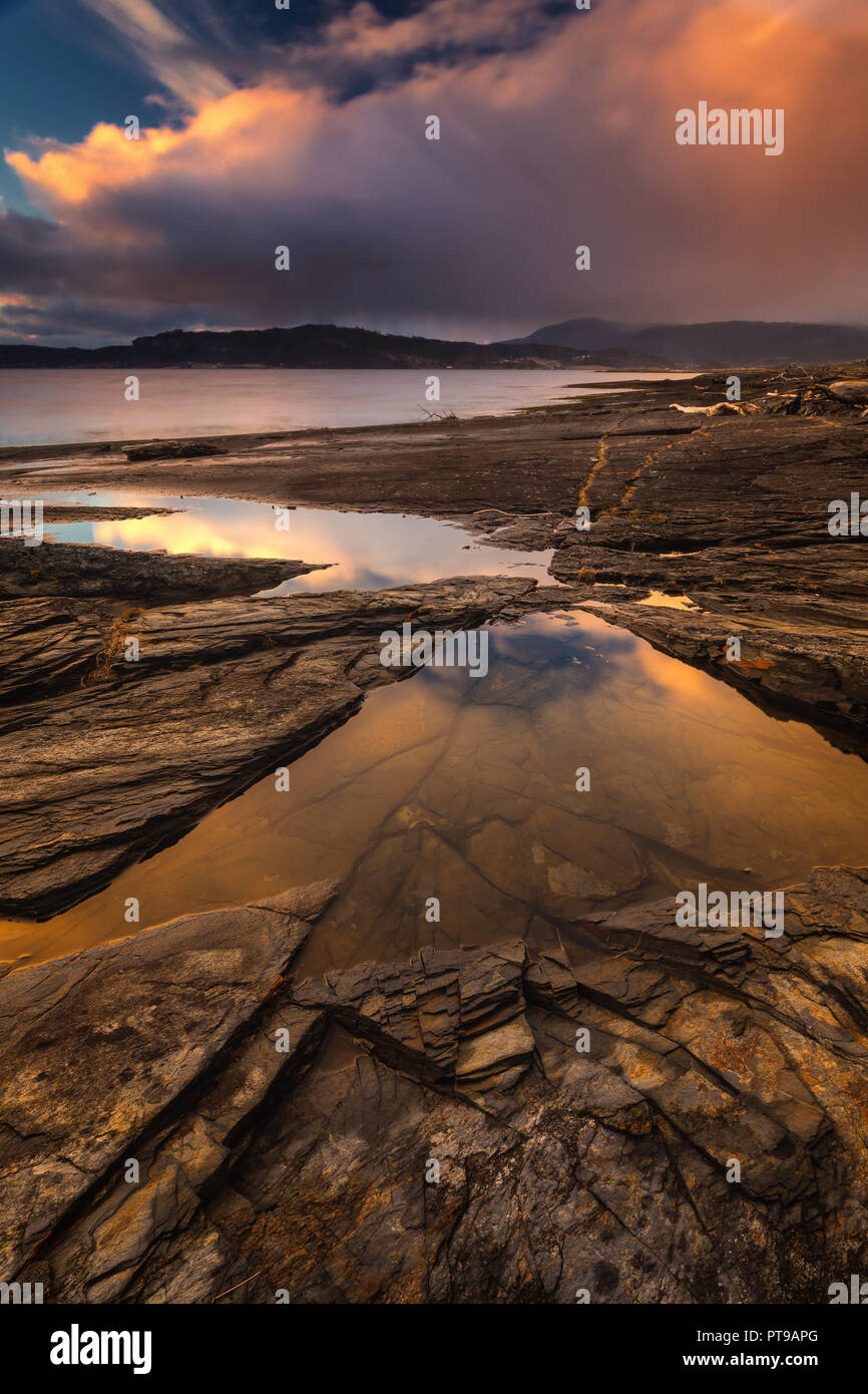 L'orario del tramonto dalla spiaggia Flatholmen in Muruvik. Incredibile Cielo e nubi di colori. Rive di Trondheimsfjorden, Norvegia. Foto Stock