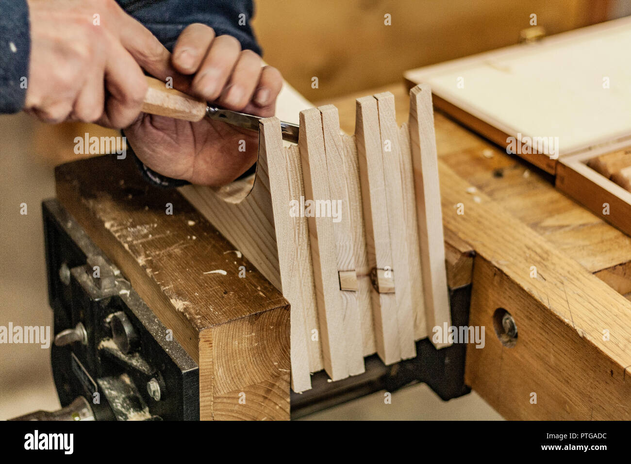 Eco-friendly falegname del negozio. Dettagli e concentrarsi sulla consistenza del materiale, segatura e ruspe o scalpelli, pur rendendo le gambe per il serraggio di un dado 24. Foto Stock