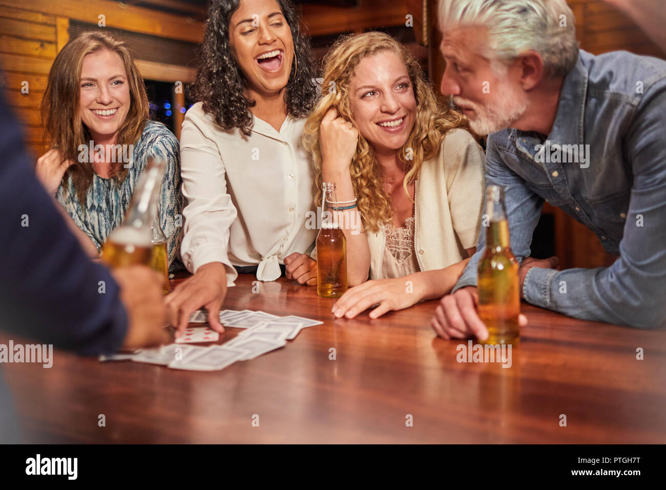 Amici a giocare gioco di carte in tavola di cabina Foto Stock