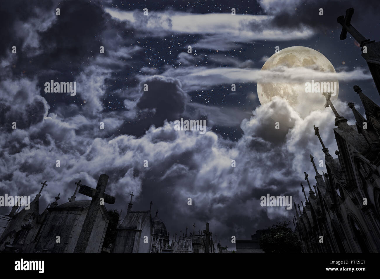 Vecchio Cimitero europeo in una notte di luna piena con molte tombe in forma di granito di cappelle con croci, nuvole e stelle. Buona per gli sfondi di halloween.P Foto Stock