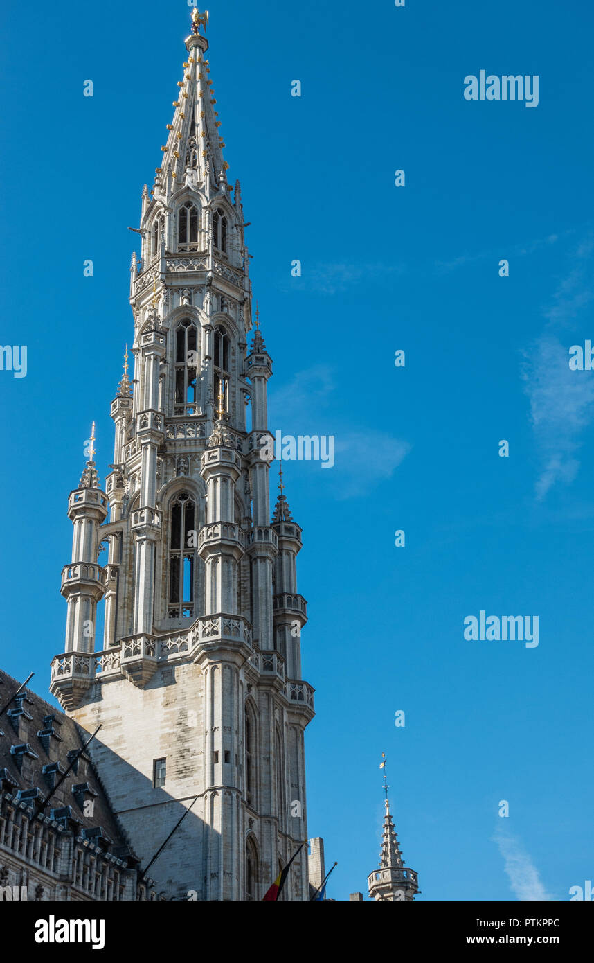 Bruxelles, Belgio - 26 Settembre 2018: la guglia e la facciata di pietra grigia municipio con statue e contro il cielo blu. Foto Stock