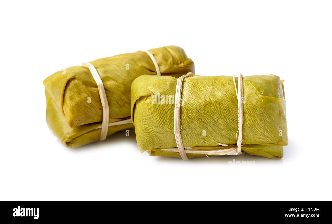 Thai dessert, al vapore riso appiccicoso con Banana Leaf isolati su sfondo bianco Foto Stock