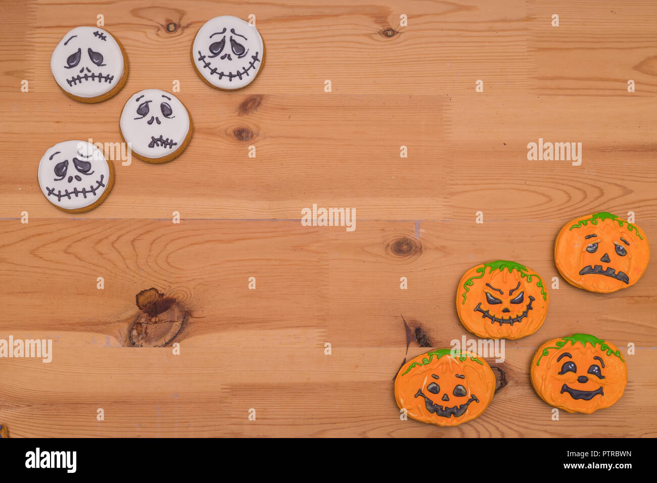 Funny Halloween Ghost i cookie. Emoticon zucche e fantasmi su una tavola di legno Foto Stock