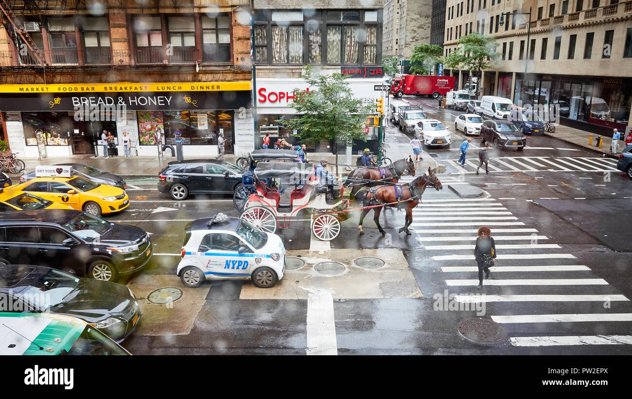 New York, Stati Uniti d'America - 28 Giugno 2018: Ottava Avenue e West 56th Street intersezione in un giorno di pioggia. Foto Stock