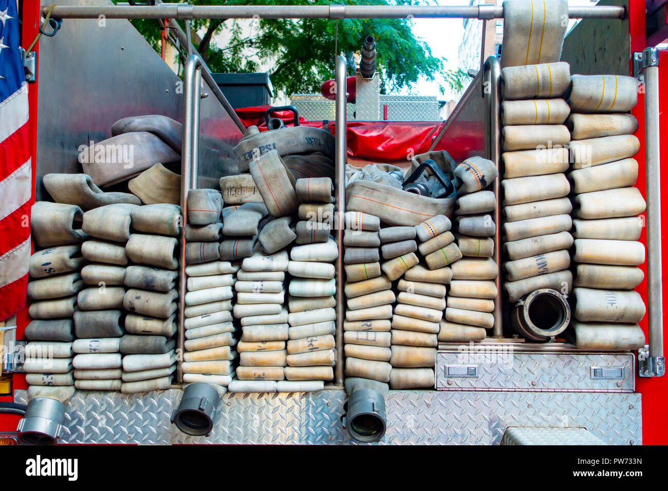 Tessuto industriale forza vigile del fuoco i tubi flessibili acqua nel retro di un firetruck Foto Stock