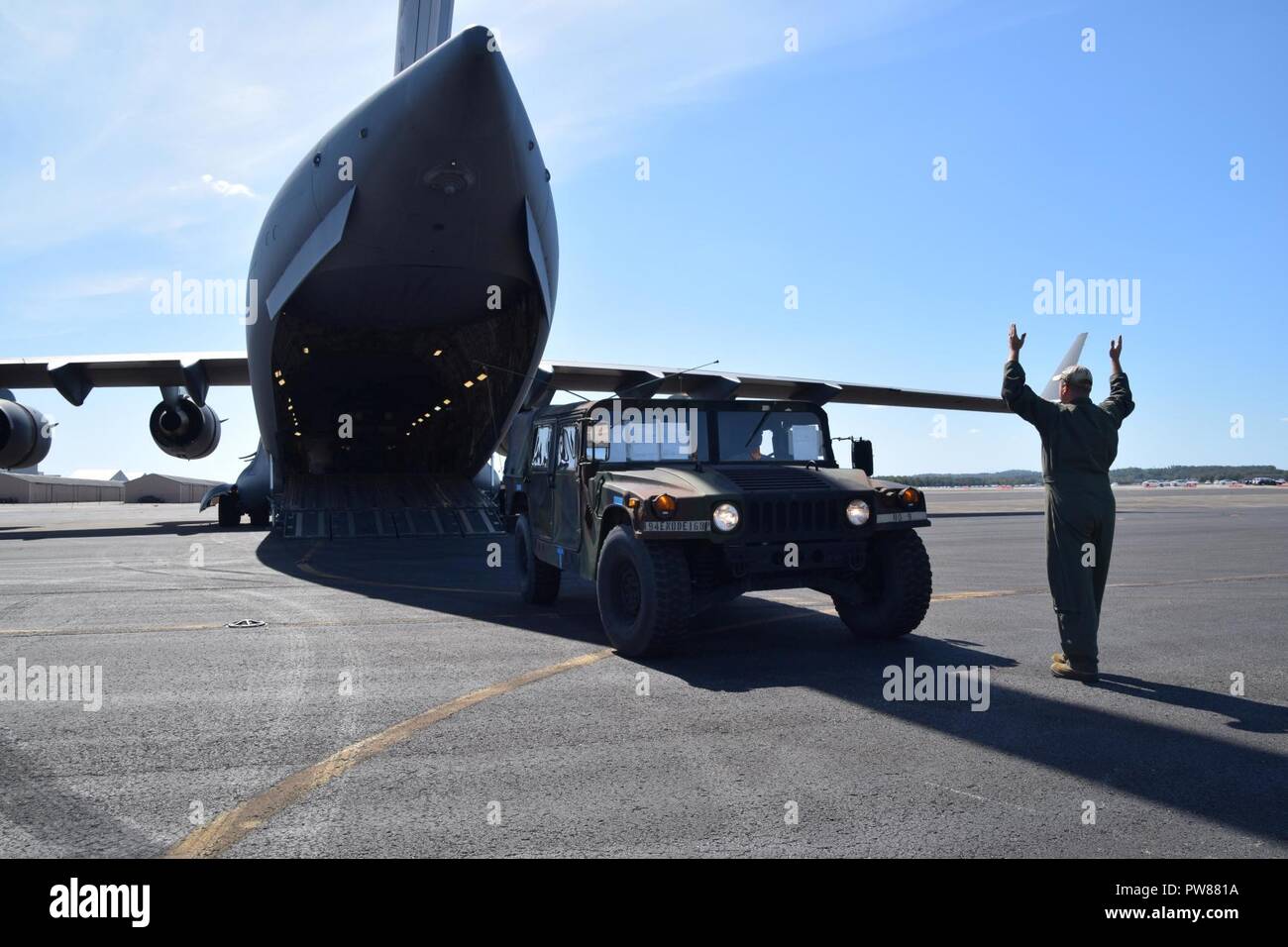 Un Tennessee Air National Guard loadmaster guide un HMMWV su un C-17 Globemaster dalla 164Airlift Wing, con sede a Memphis, Tennessee, come parte di una situazione di emergenza della polizia militare dal 252nd MP Co., Tennessee Esercito nazionale di guardia di Smirne. Il 252nd fornito supporto continuo dell'Uragano Irma soccorsi negli Stati Uniti Isole Vergini. Foto Stock