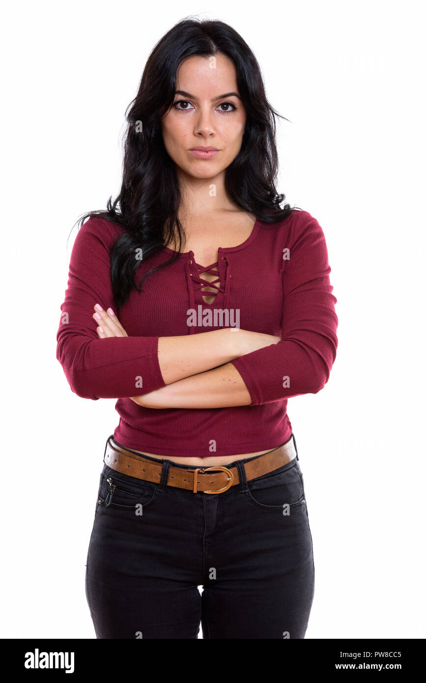 Studio shot del giovane bella donna spagnola in piedi con le braccia Foto Stock