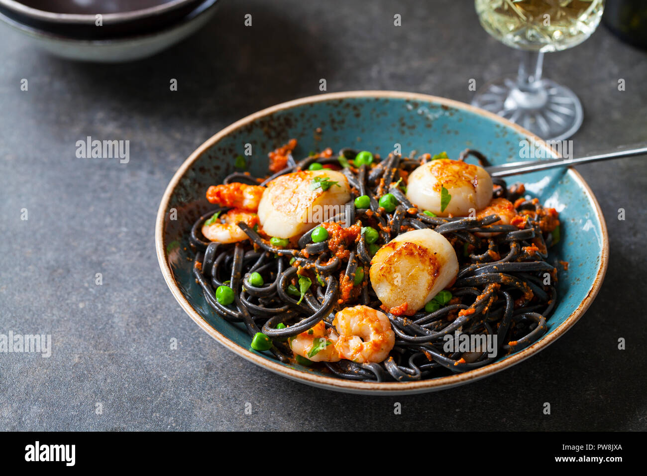 Squid ink pasta con gamberi e capesante Foto Stock