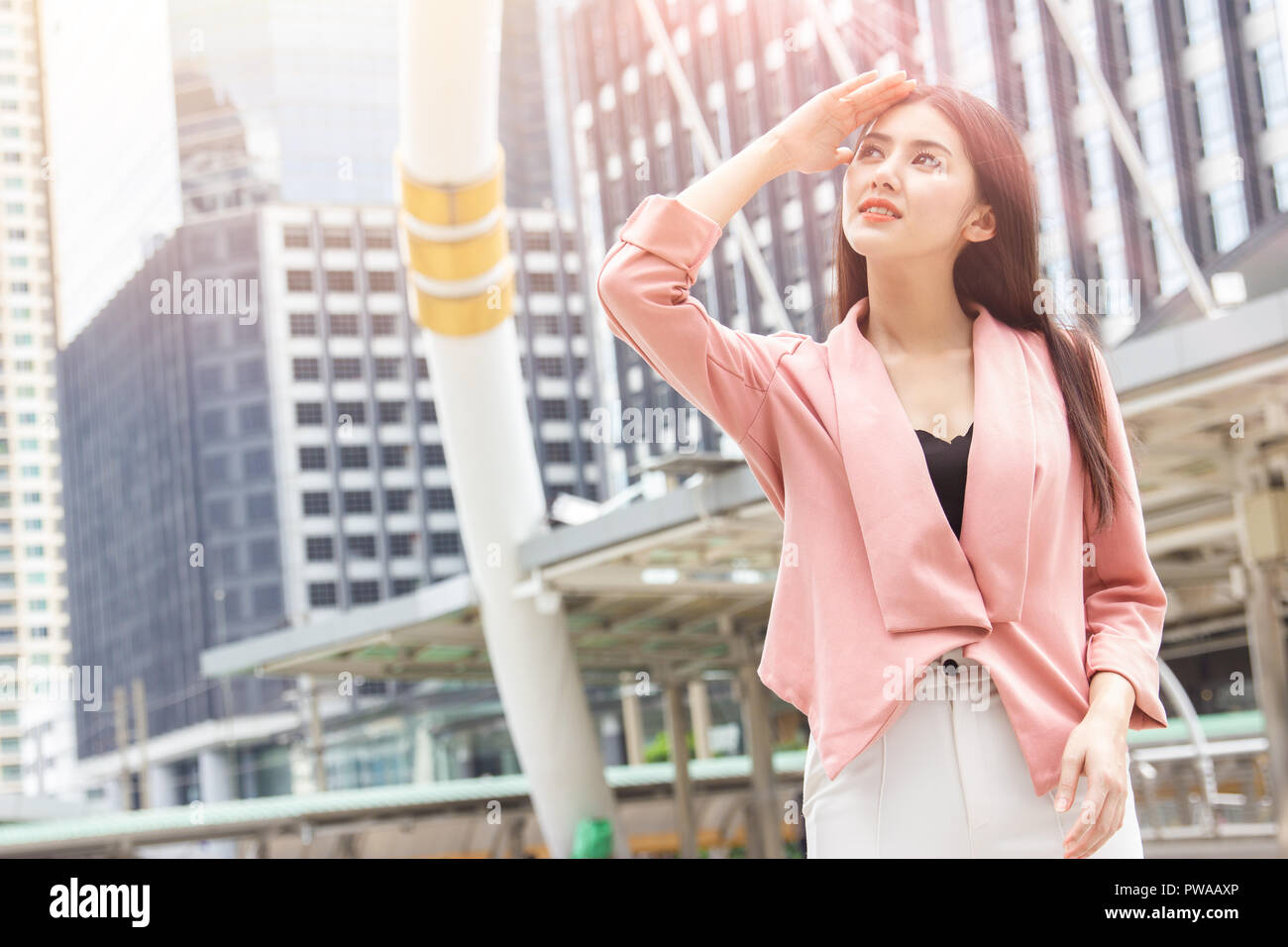 Ufficio asiatiche donne di danneggiare la pelle dal sole città UV inquinamento atmosferico concetto Foto Stock