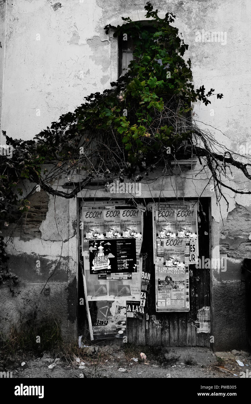 Il vecchio edificio in disuso nel nord della Spagna. Trascurato e coperto con vecchi manifesti stracciati Foto Stock