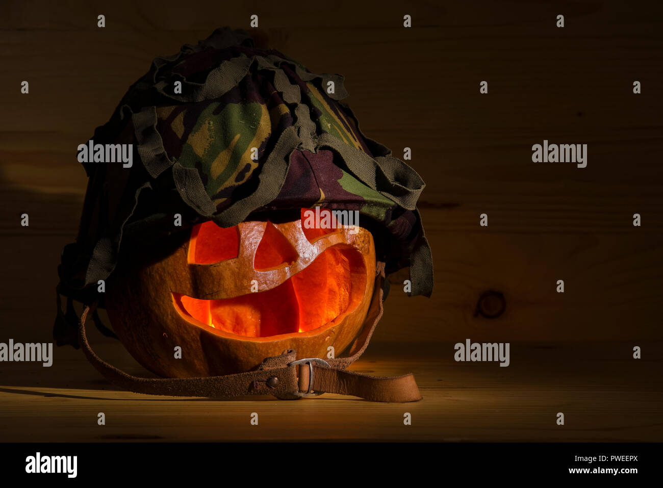 Jack-o-Lantern "spirito guerriero' in un elmetto militare e macchina-munizioni pistola. Foto Stock