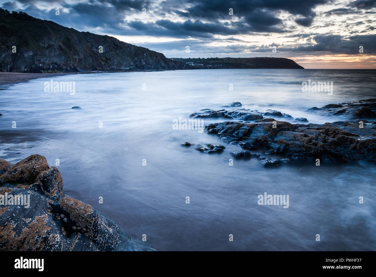 Tramonto sulla spiaggia di Tresaith in Ceredigion, Galles, guardando verso Aberporth. Foto Stock