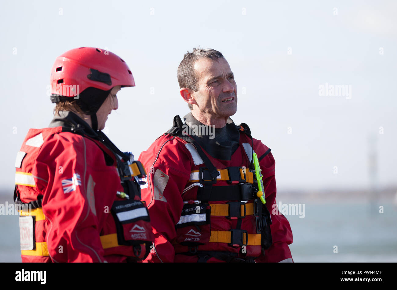 Due guardie costiere discussione permanente di lavoro Foto Stock