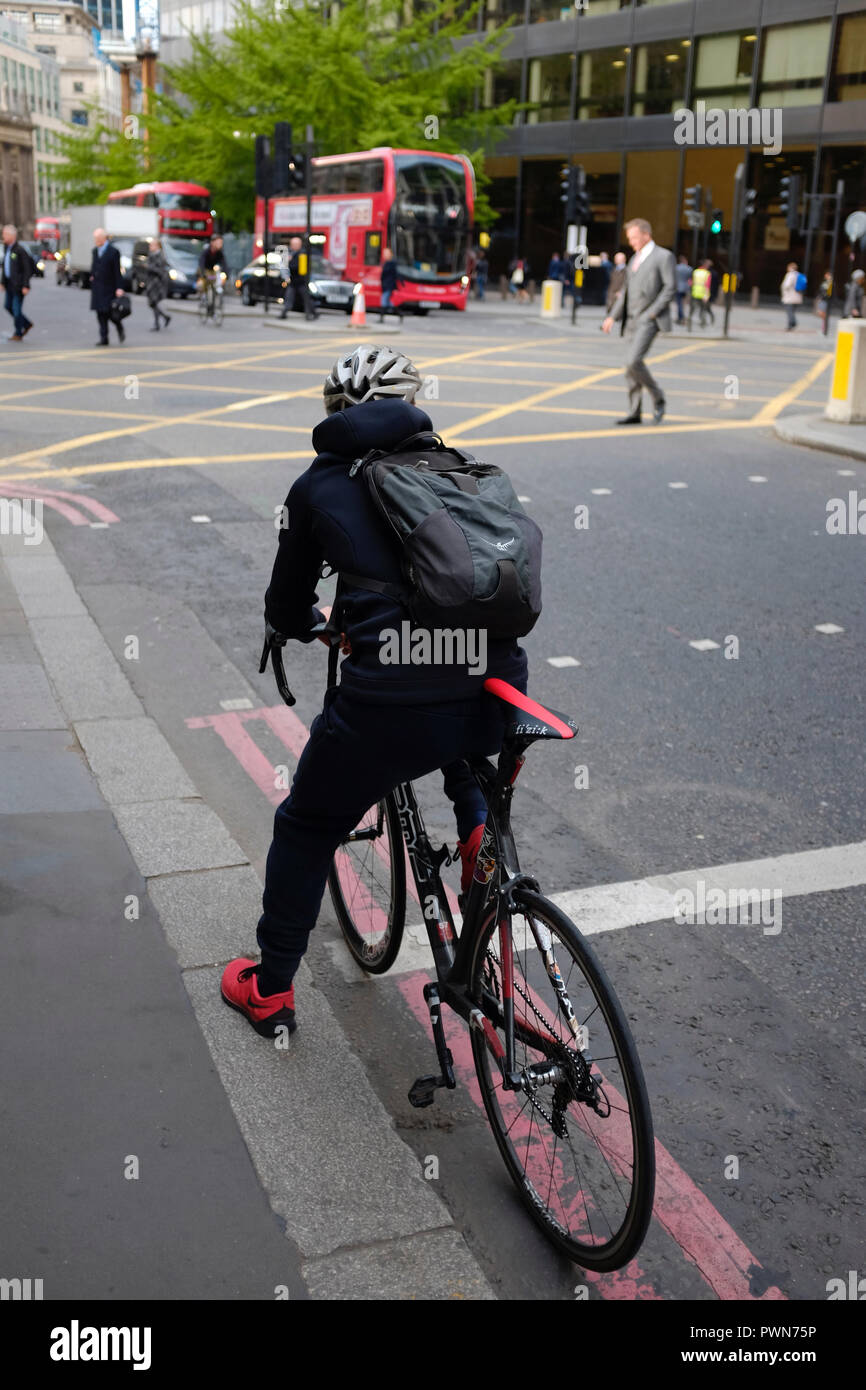 Un ciclista in attesa di un semaforo in Londra, Regno Unito Foto Stock