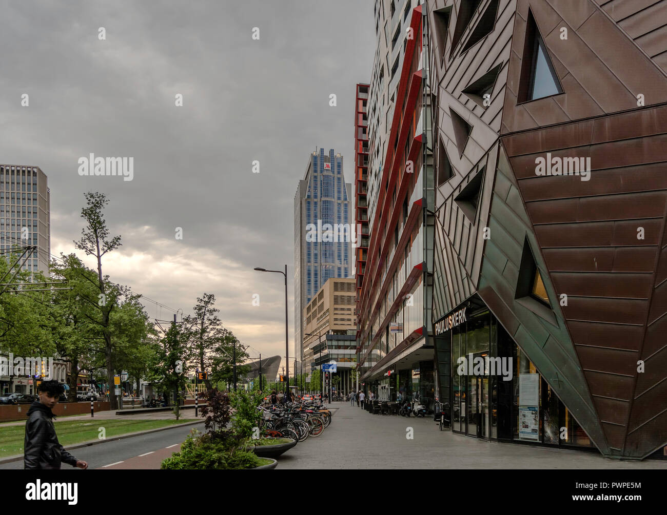 Una delle strade di Rotterdam con moderne e innovative edifici contemporanei nuvoloso in serata primaverile. Foto Stock
