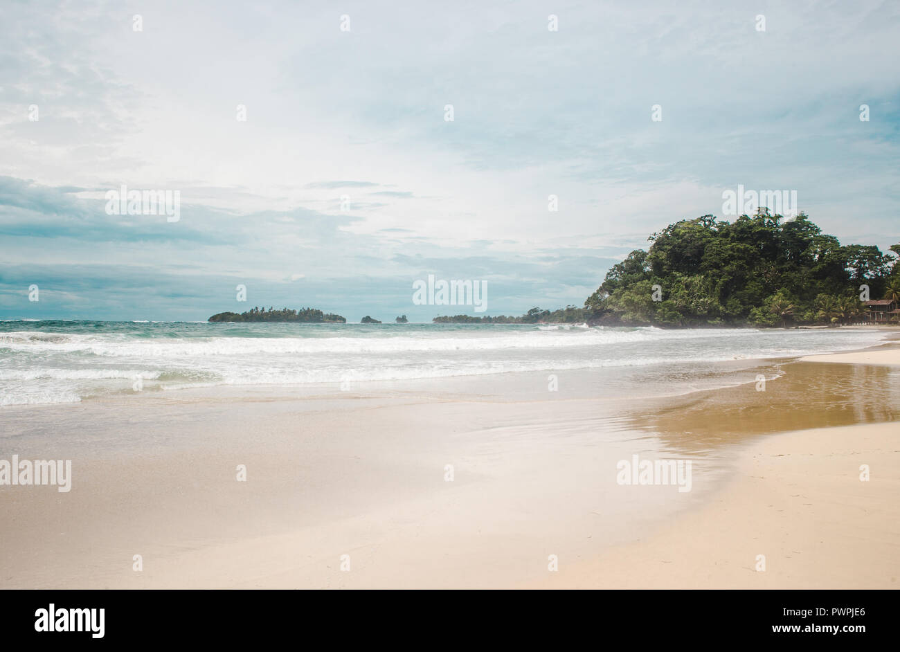 Giornata di vento sulla vasta spiaggia di sabbia bianca di rana rossa Beach, un isola dei Caraibi al largo della costa di Panama Foto Stock