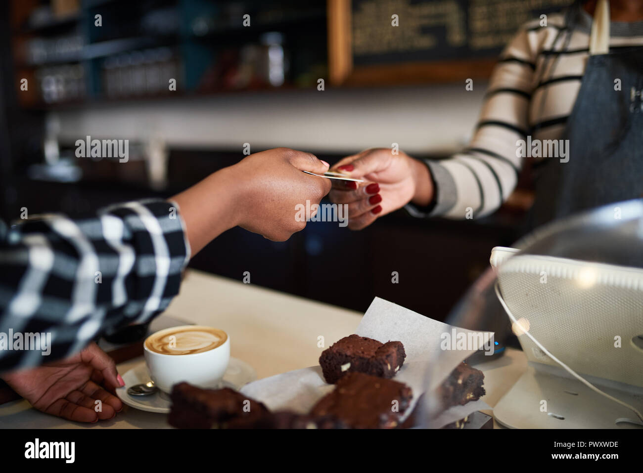 Cafe il cliente paga per un ordine con la sua carta di credito Foto Stock