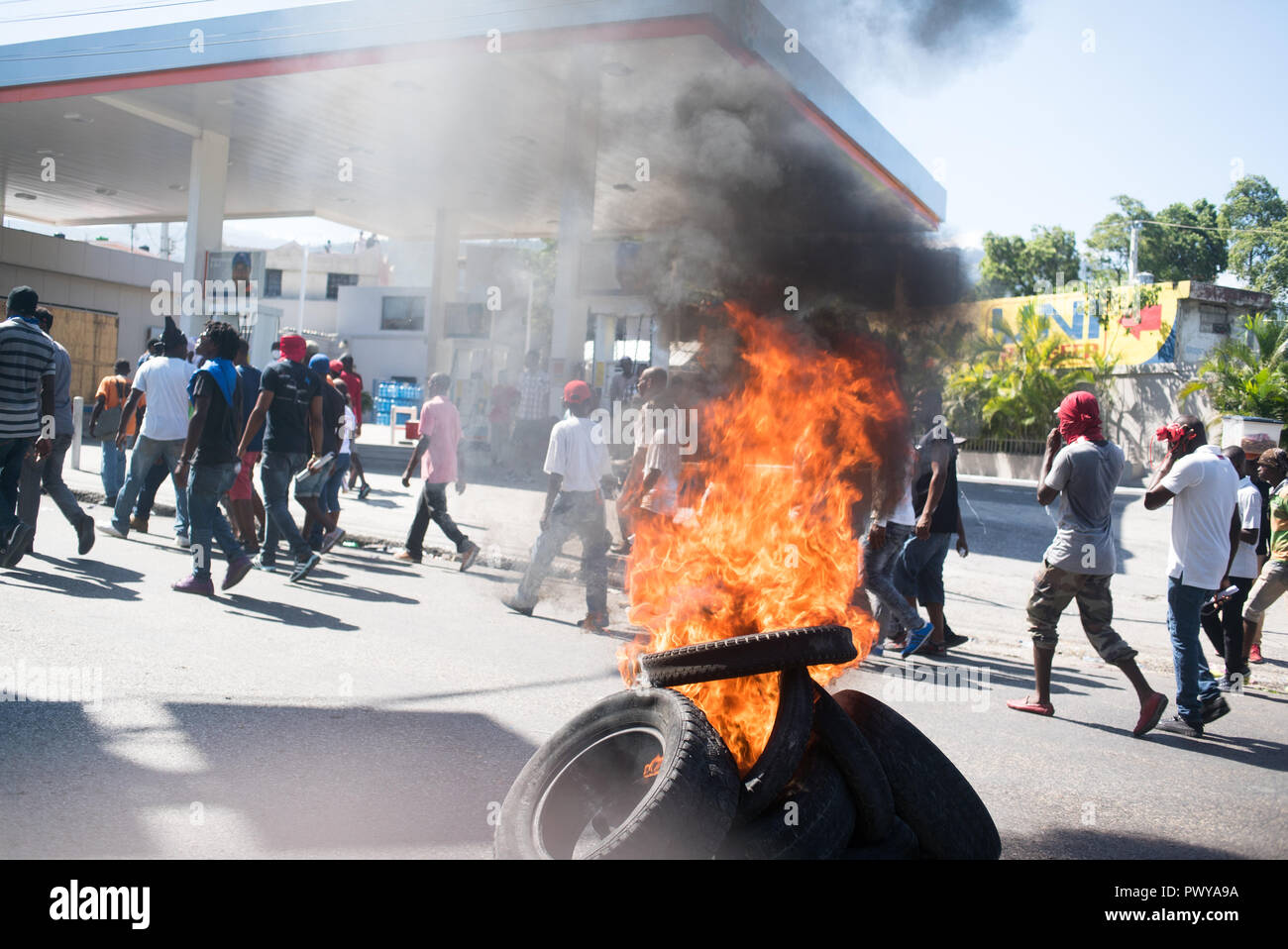 Copertoni bruciati nelle strade di decine di migliaia di manifestanti marzo lungo le strade. I dimostranti si sono riuniti per manifestare contro i $3.8 miliardi di euro che il governo e le imprese private sono stati accusati di aver embezzling dal Venezuela del PetroCaribe sovvenzionate programma del petrolio. Le entrate doveva andare verso il finanziamento dei programmi economici e sociali. Il PetroCaribe sfida era iniziata dopo la regista haitiana Gilbert Mirambeau Jr. Posted on social media chiedendo: "Kot Kòb PetroCaribe a," o "dove ha fatto il PetroCaribe denaro andare?" con una grande gioventù, grassroots base dimostrazioni su tutto il territorio nazionale attraverso H Foto Stock