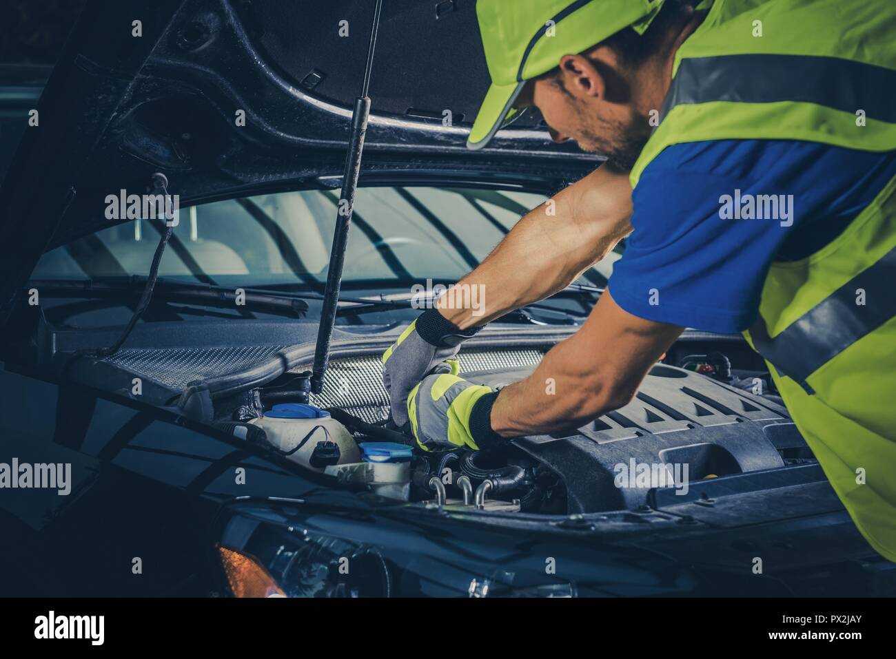 Caucasica Assistenza stradale meccanico di dare una occhiata al di sotto del cofano per auto. Foto Stock