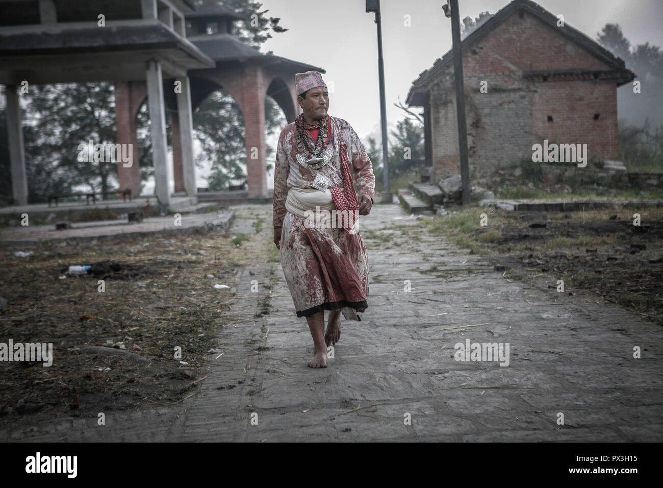 Bhaktapur, Nepal. Xix oct, 2018. Un sacerdote a piedi il tempio Bramahini mattina presto a adora durante il decimo giorno del festival di Dashain.Durante il Festival di Dashain nepalesi, devoti indù culto Durga, una dea madre di potere e di prosperità, offrendo sacrifici di animali, soprattutto di capra e di bufala. In generale, il Dashain festival indù è una celebrazione della vittoria degli dèi sui demoni. Credito: Sunil Pradhan SOPA/images/ZUMA filo/Alamy Live News Foto Stock