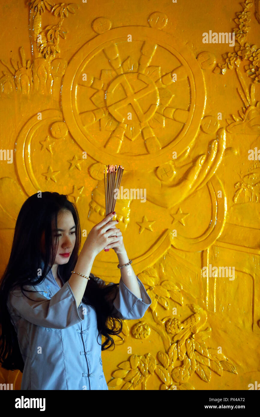Thien appeso tempio buddista. Pregando donna con bastoncini di incenso in mani. Ho Chi Minh City. Il Vietnam. Foto Stock