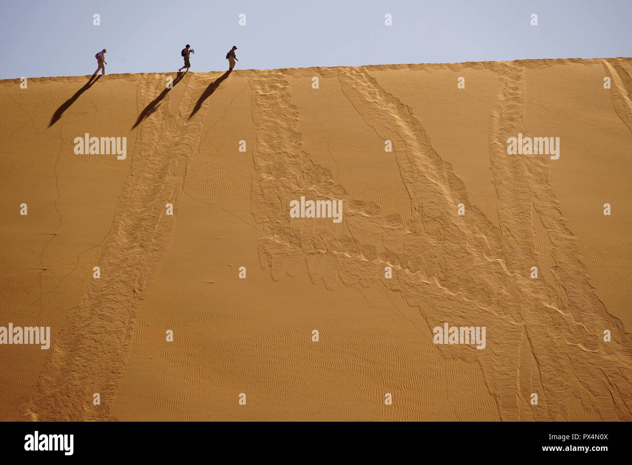 Touristen laufen auf dem Kamm der Düne, Sossusvlei, Namibia, Afrika Foto Stock