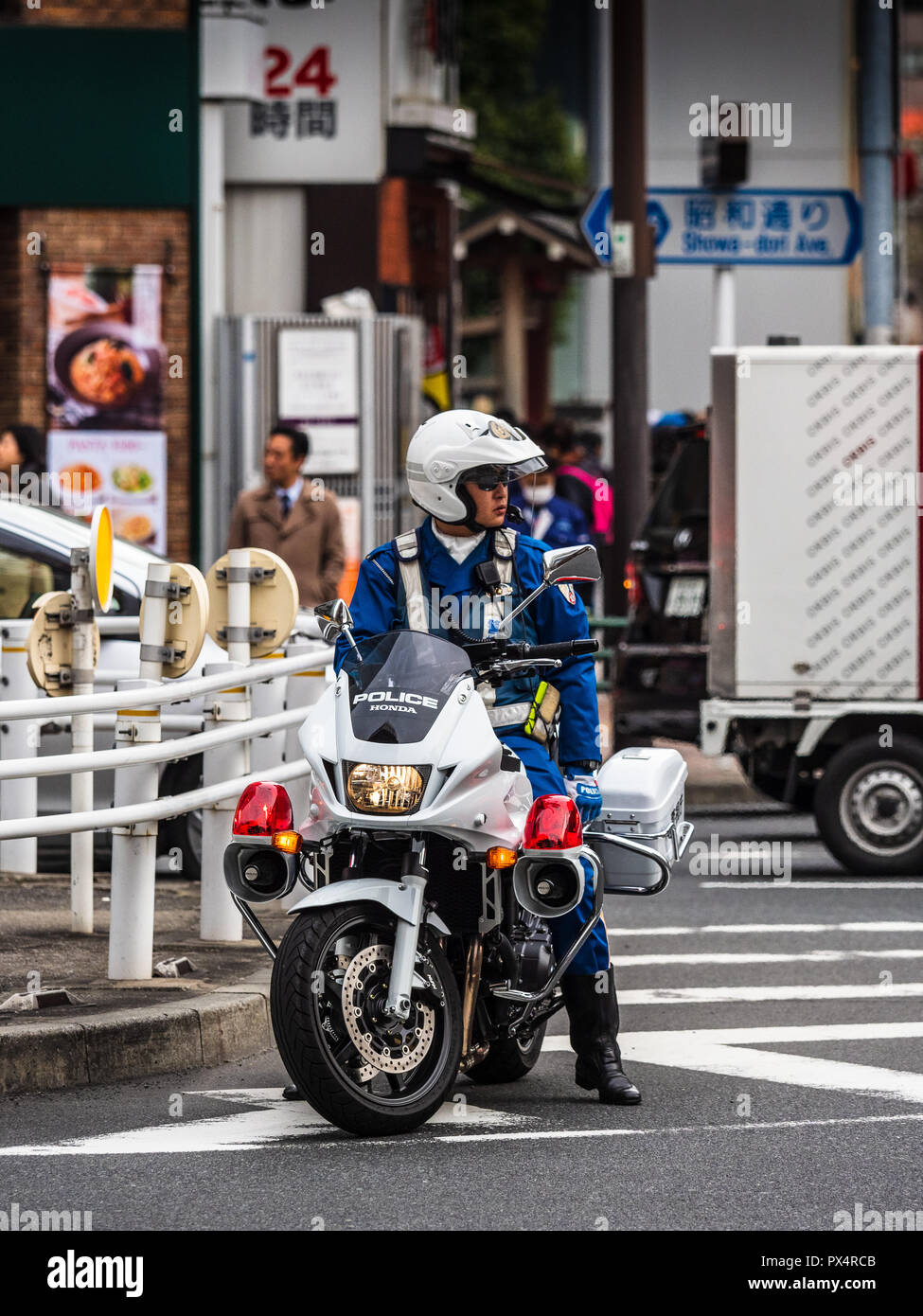 Tokyo Giappone polizia motociclista attende in corrispondenza di una giunzione a Tokyo Foto Stock