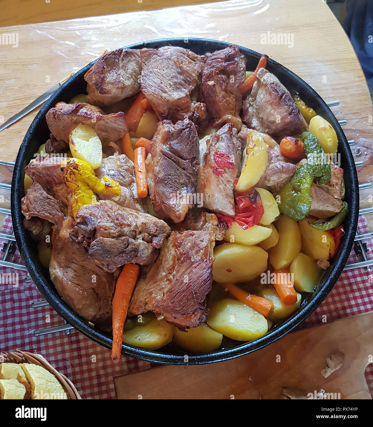 Tradizionale piatto croato Peka vista, la carne e le verdure nel coperchio di ferro sotto la luce calda Foto Stock