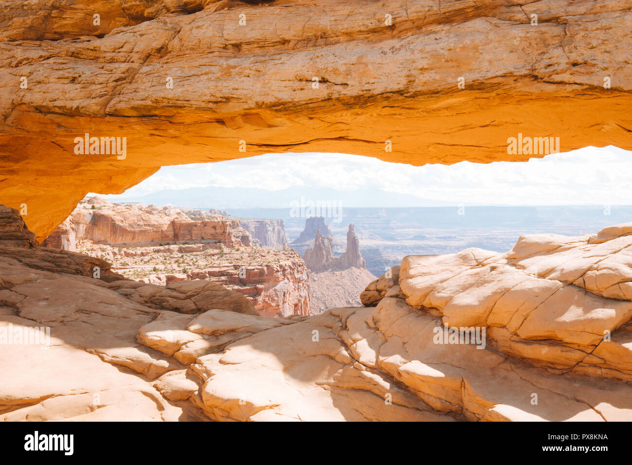 Visualizzazione classica del famoso Mesa Arch, simbolo del sud-ovest americano, illuminata a scenic golden. La luce del mattino al sorgere del sole su una bella giornata in estate Foto Stock