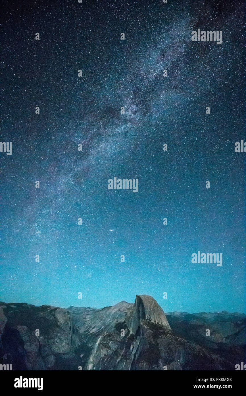 Vista panoramica del bellissimo cielo stellato con Via Lattea sopra metà picco cupola illuminata dalla luna piena in estate, il Parco Nazionale di Yosemite, Californi Foto Stock