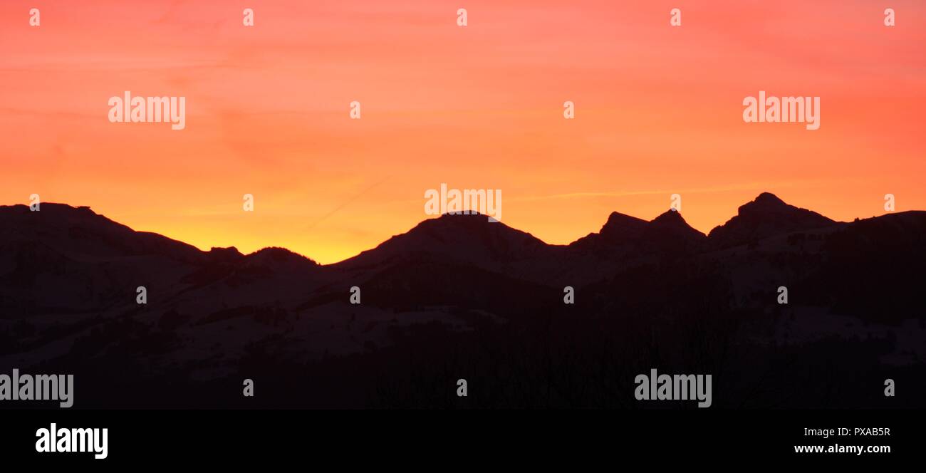 Silhouette di una catena montuosa al calar della sera Foto Stock