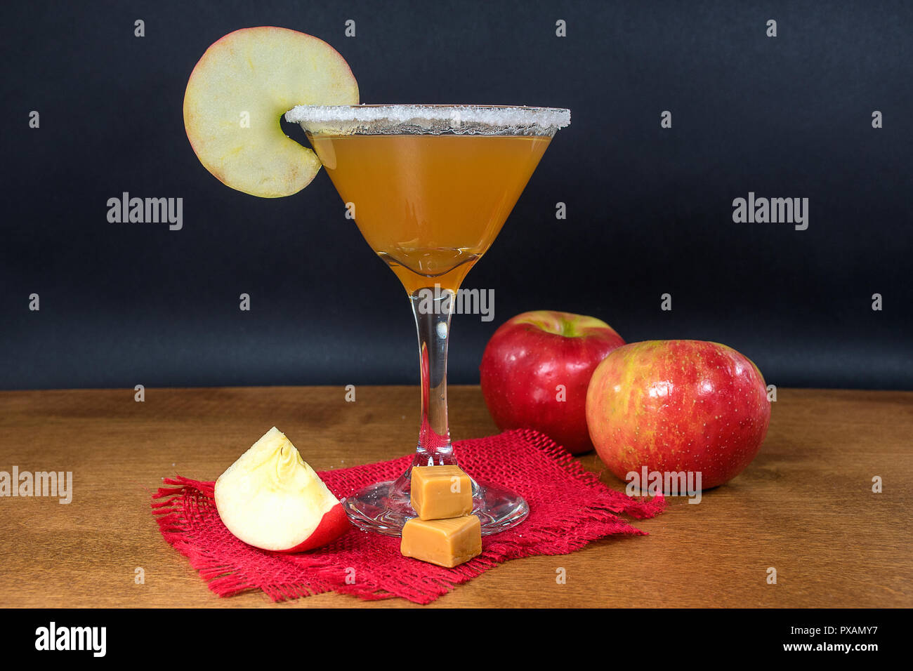Sidro di mela martini con caramello mele e mele mature sulla tavola di legno Foto Stock