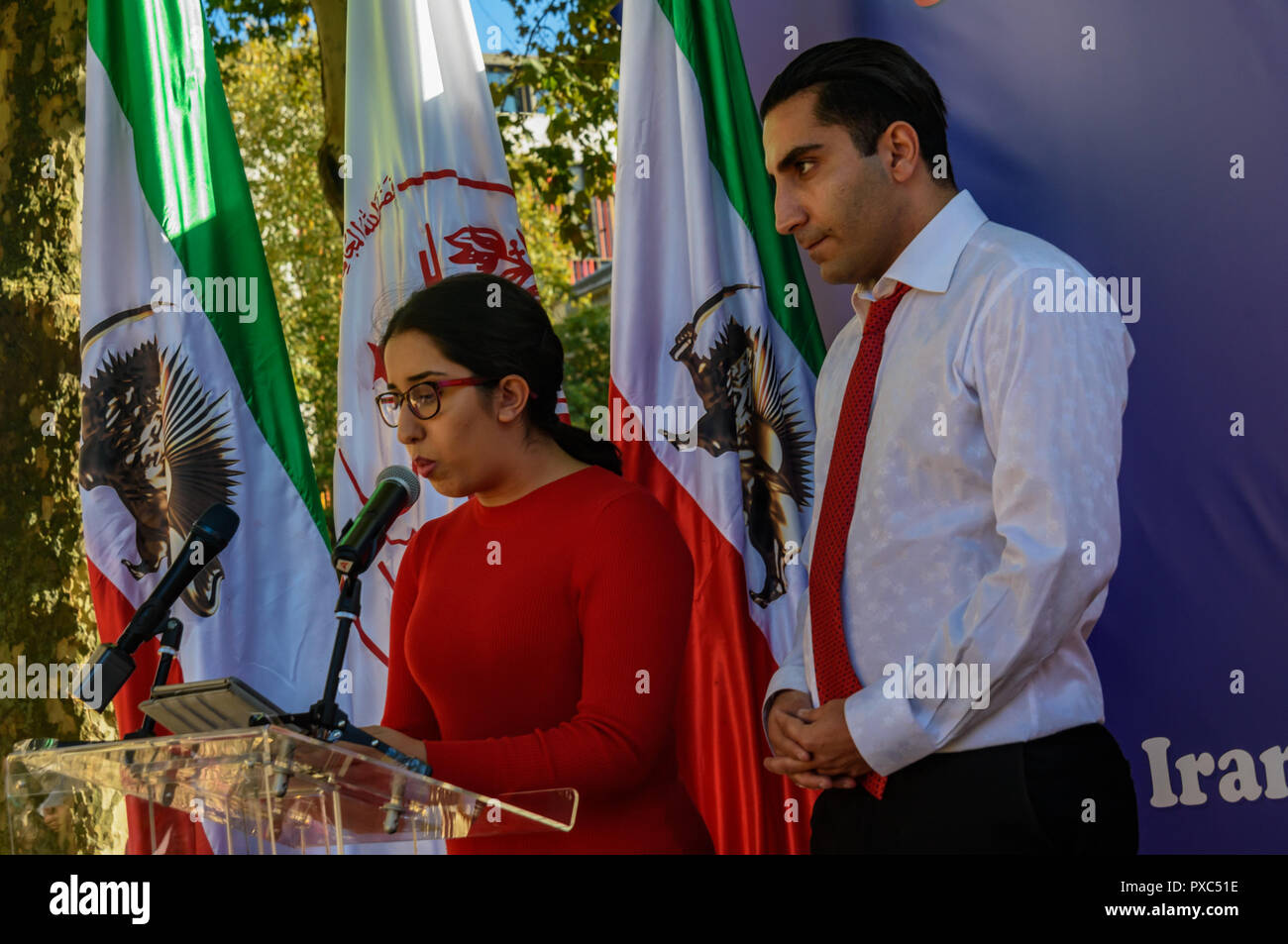 Londra, Regno Unito. 20 ott 2018. Una donna parla all'OMPI protesta. Dietro un banner "democrazia in Iran con Maryam Rajavi', Mujaheddin del popolo dell'Iran terrà una manifestazione di protesta contro la repressione del regime attuale in Iran con un patibolo e tre donne detenute in una cella di prigione che illustra il regno del terrore vi e per chiedere la fine delle esecuzioni ci, . politico e sociale di Credito ri: ZUMA Press, Inc./Alamy Live News Foto Stock