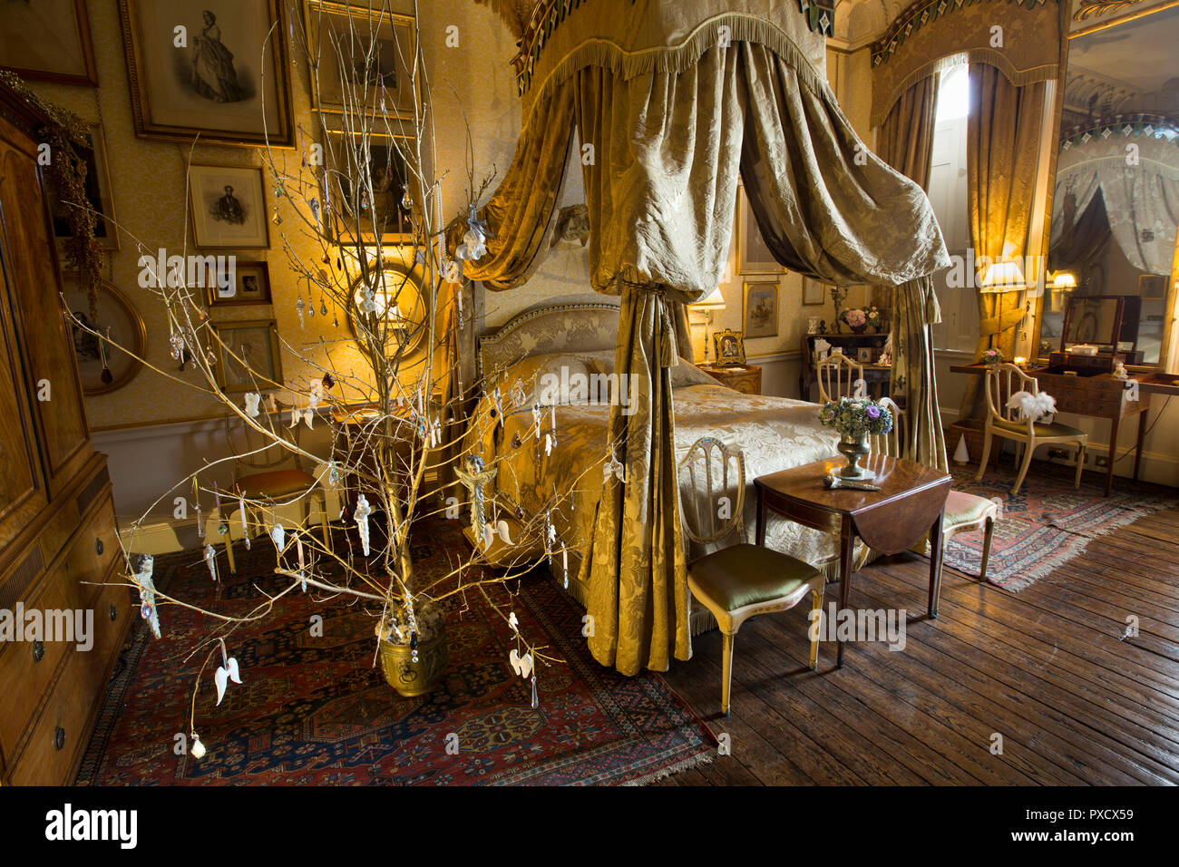 Regno Unito, Inghilterra, Yorkshire, Castle Howard a Natale, Lady Georgiana la camera da letto, decorate in maniera semplice albero di diramazione accanto al letto a baldacchino Foto Stock