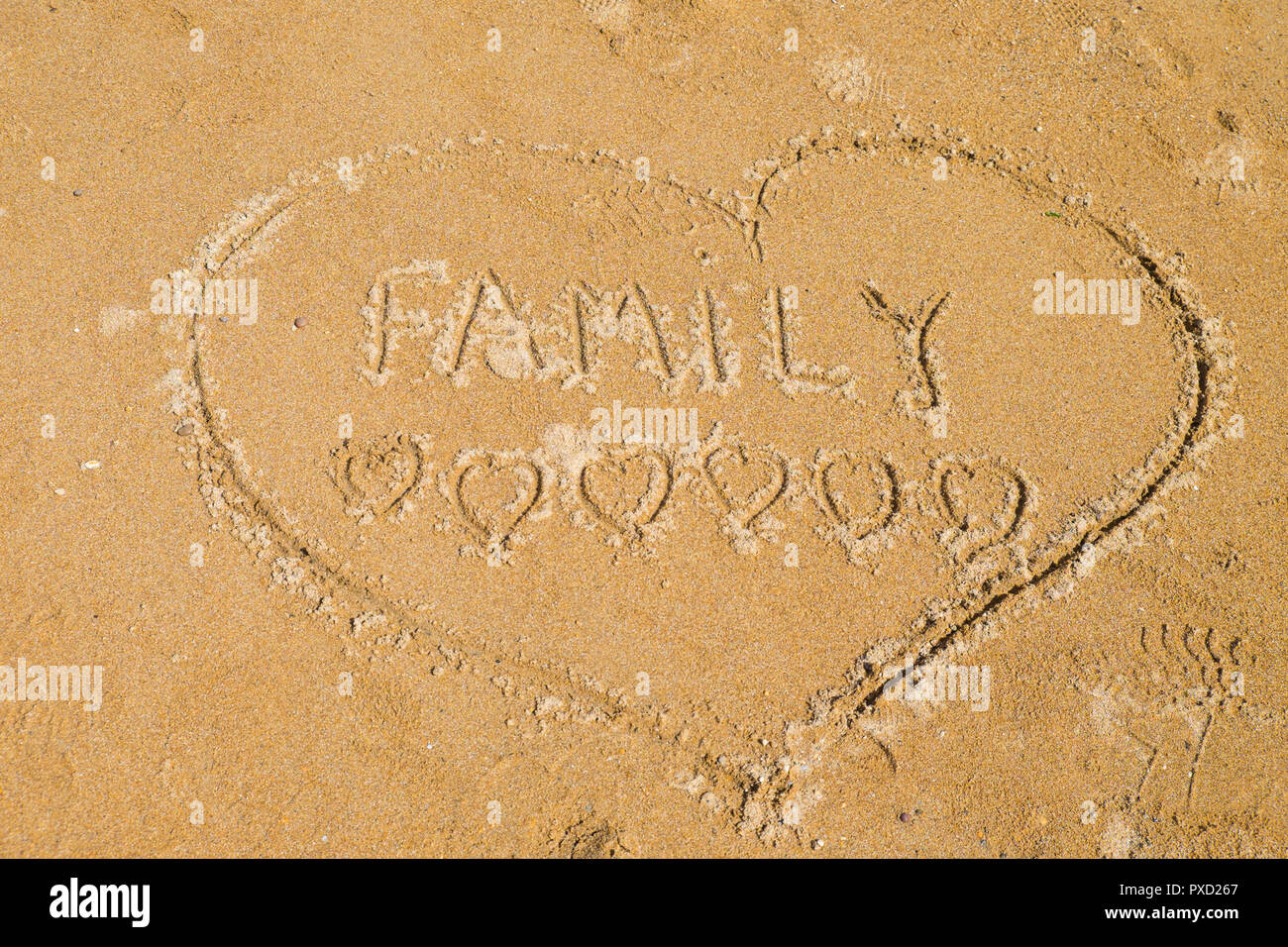 Amore Familiare; segno nella sabbia Foto Stock