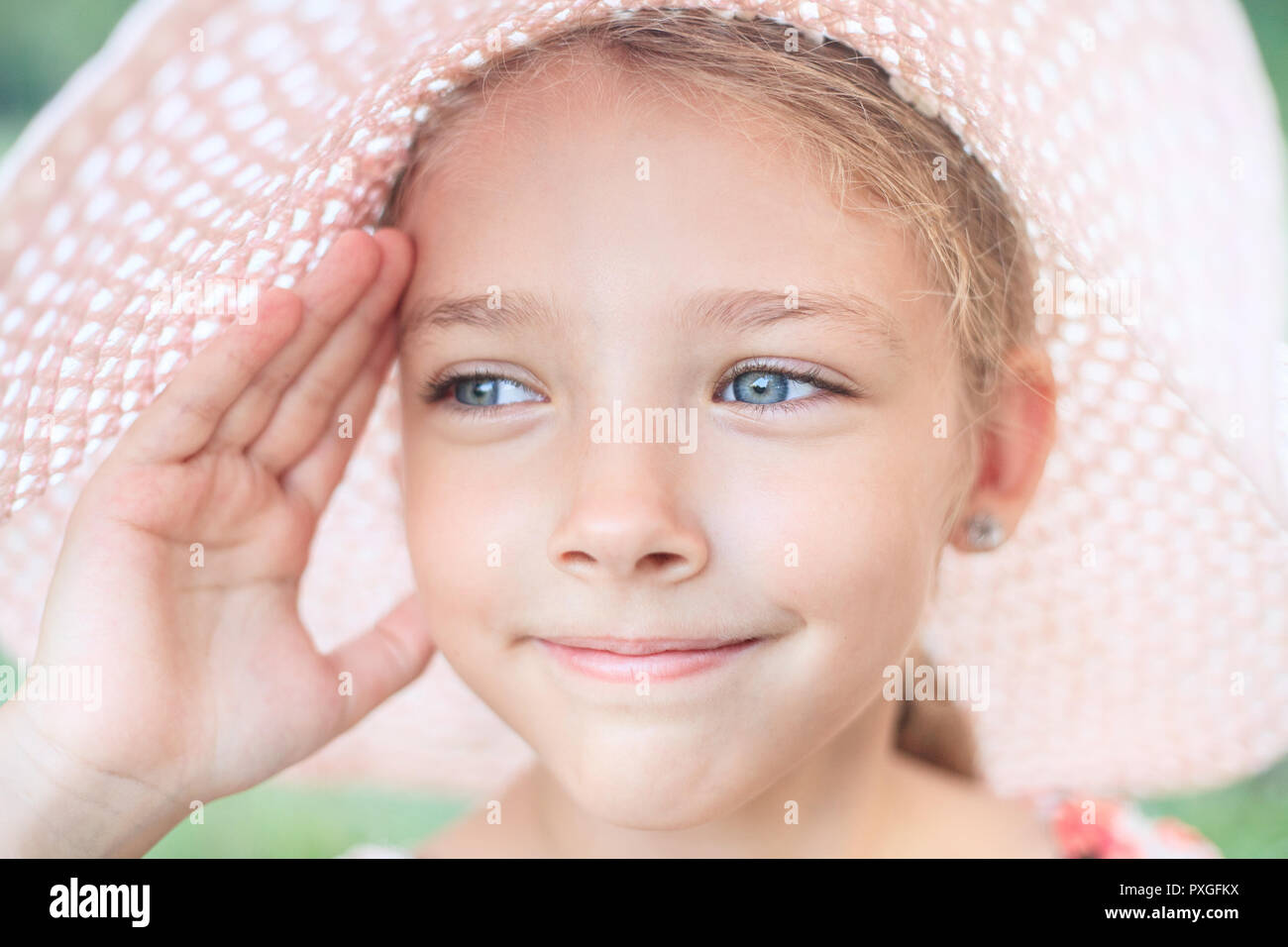 Estate ritratto di una bella ragazza in un cappello rosa. Il concetto di infanzia e vacanze. Foto Stock