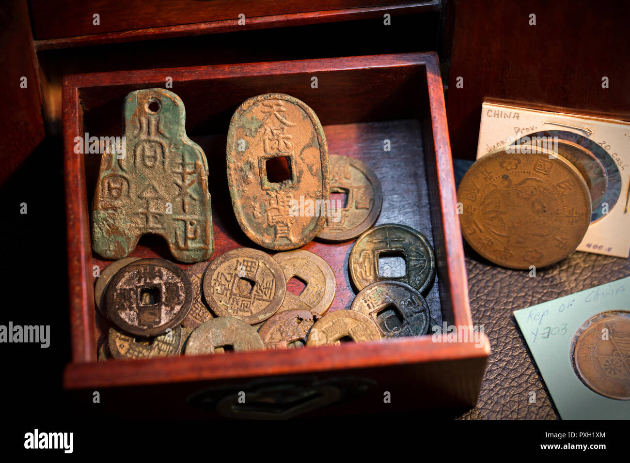 Oriental cassa di legno ospita un piccolo tesoro di antiche giapponese e  cinese monete in bronzo e le texture di metalli di invecchiamento Foto  stock - Alamy