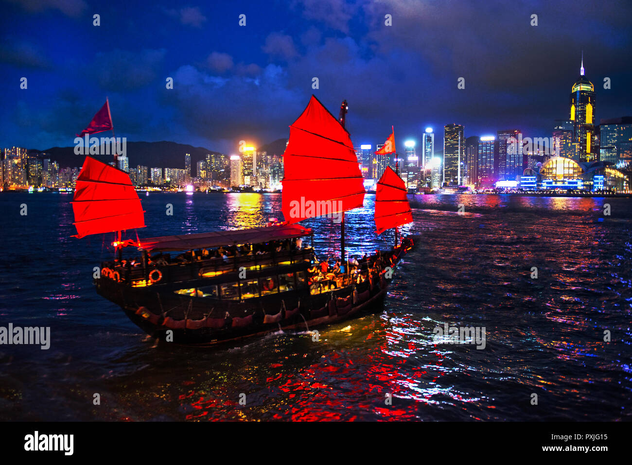 Victoria Harbour Hong Kong vista notturna con nave posta indesiderata in primo piano Foto Stock