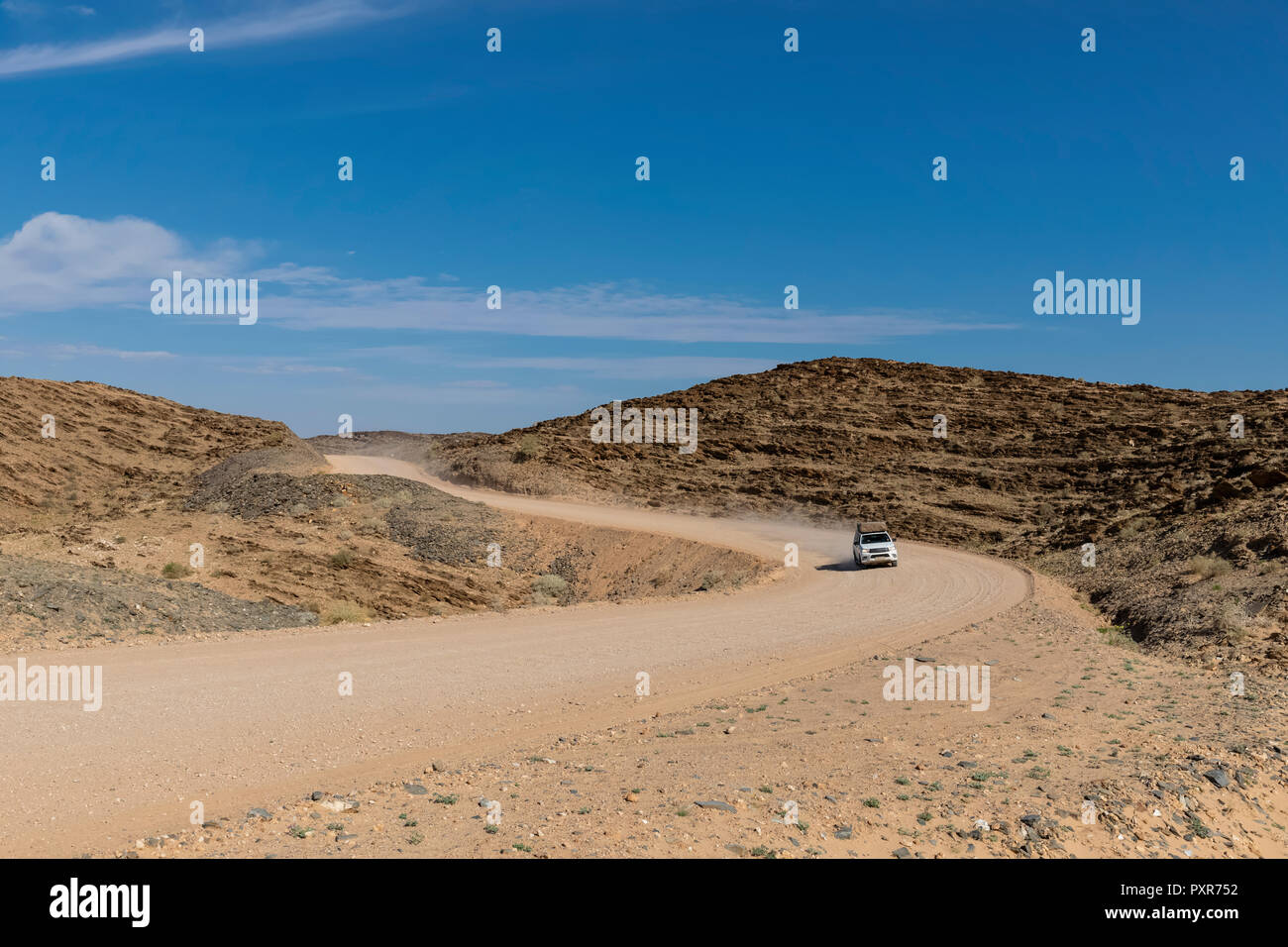 In Africa, la Namibia, il deserto del Namib Naukluft, Parco Nazionale, veicolo fuoristrada su strada di ghiaia Foto Stock