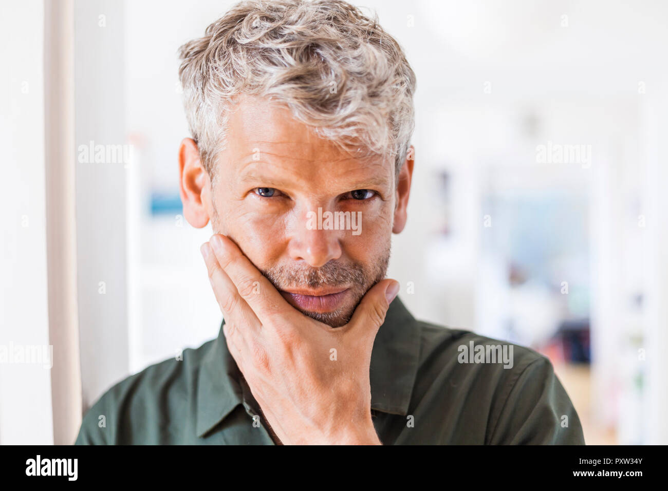 Ritratto di uomo maturo con i capelli grigi e di stoppie a casa Foto Stock